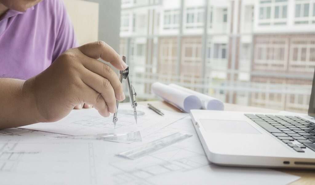 hands engineer working blueprint construction concept engineering tools vintage tone retro filter effect soft focus selective focus