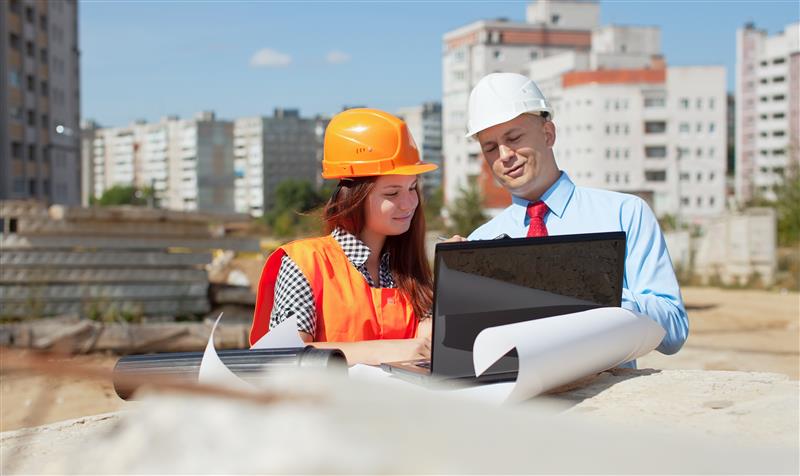 two architects front building site